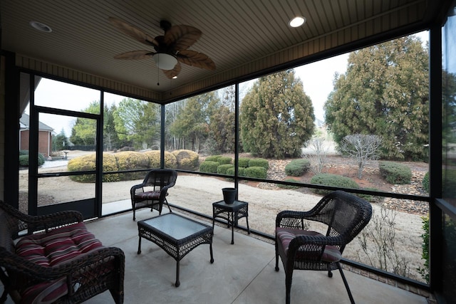 sunroom / solarium featuring ceiling fan