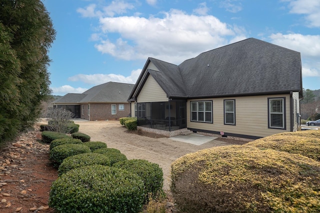 back of property with a patio area and a sunroom