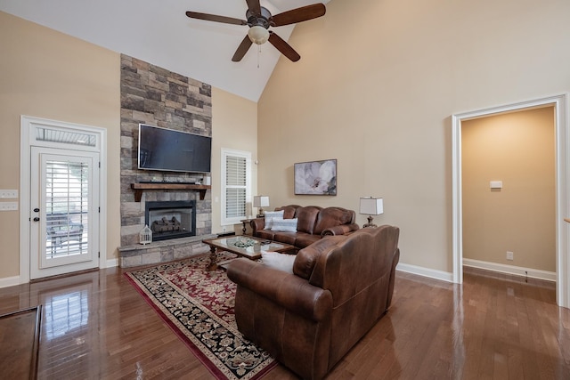 living room with ceiling fan, a fireplace, high vaulted ceiling, and wood-type flooring