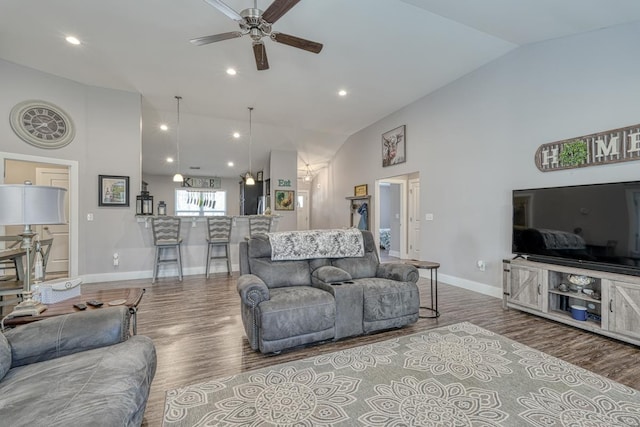 living room with hardwood / wood-style flooring, high vaulted ceiling, and ceiling fan