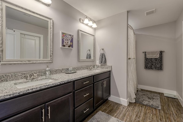 bathroom with vanity and hardwood / wood-style flooring