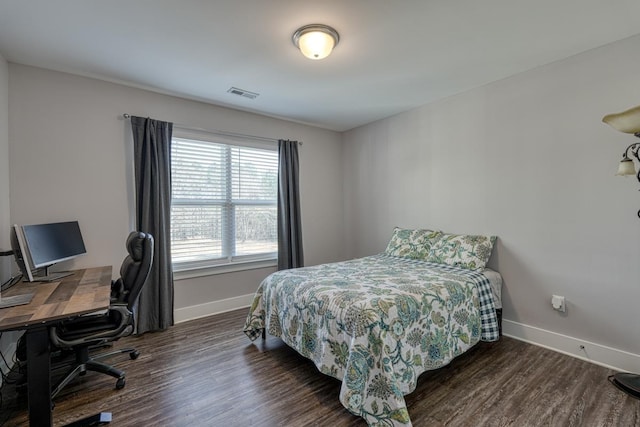 bedroom with dark hardwood / wood-style flooring