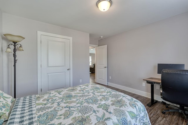 bedroom with dark hardwood / wood-style floors