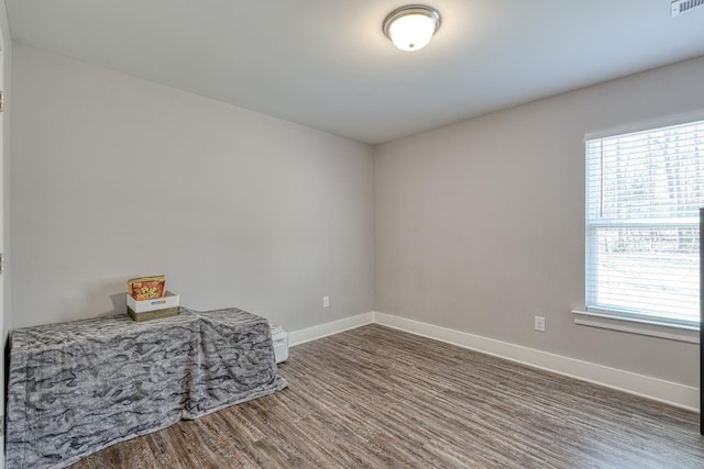 spare room featuring dark hardwood / wood-style flooring