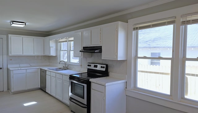 kitchen featuring sink, white cabinetry, crown molding, appliances with stainless steel finishes, and backsplash