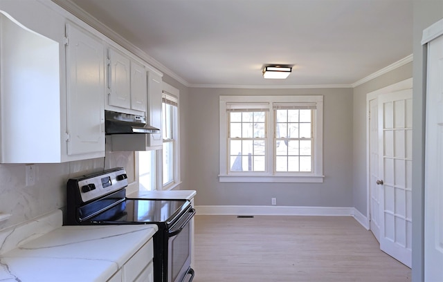 kitchen featuring white cabinetry, backsplash, ornamental molding, light hardwood / wood-style floors, and stainless steel electric stove