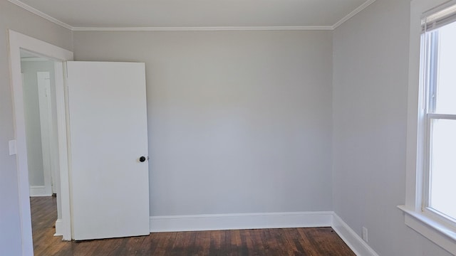 spare room with crown molding and dark hardwood / wood-style floors