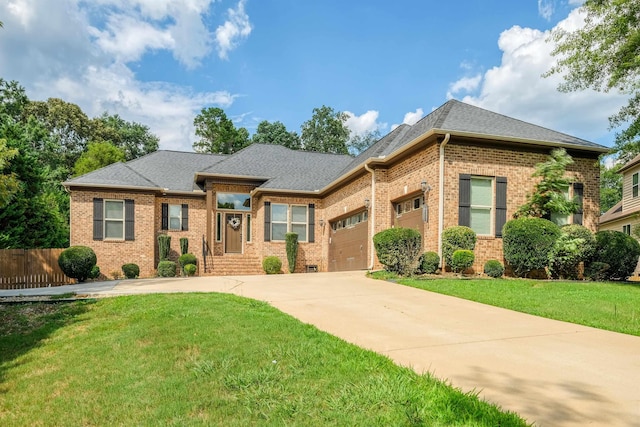 view of front of house featuring a garage and a front lawn