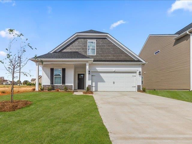 craftsman-style home with a garage and a front lawn