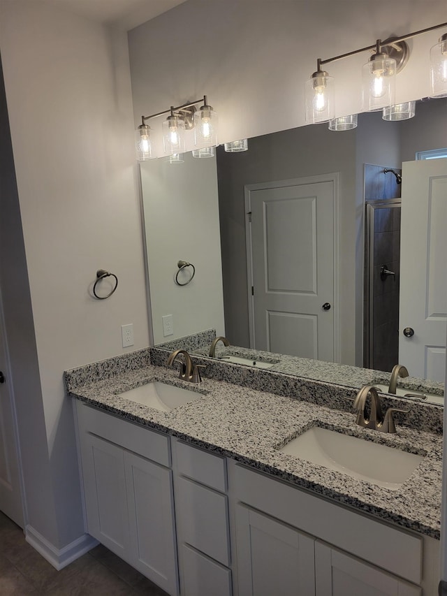 bathroom featuring an enclosed shower, vanity, and tile patterned floors