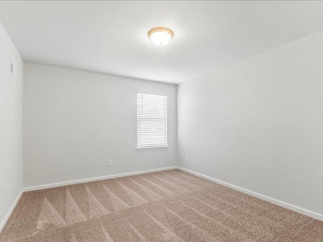 unfurnished room featuring carpet