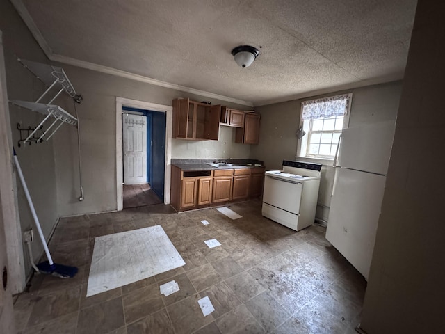 kitchen with crown molding, sink, white appliances, and a textured ceiling