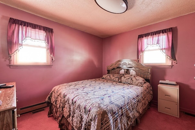 bedroom featuring visible vents, a baseboard heating unit, carpet flooring, and a textured ceiling