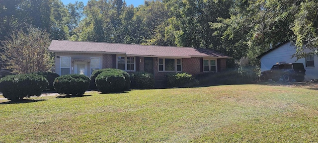 single story home with a front lawn and brick siding