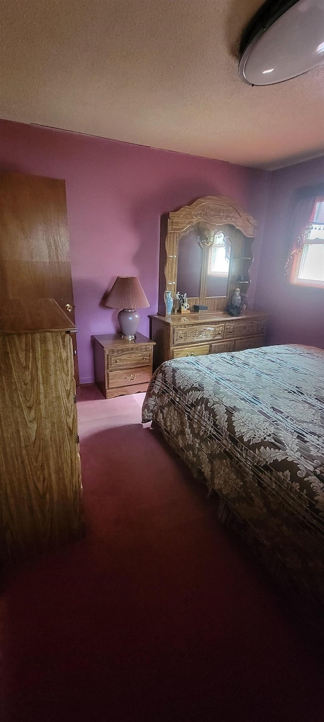 carpeted bedroom with a textured ceiling