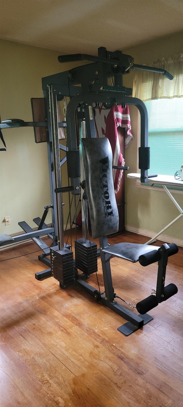 workout area with wood finished floors