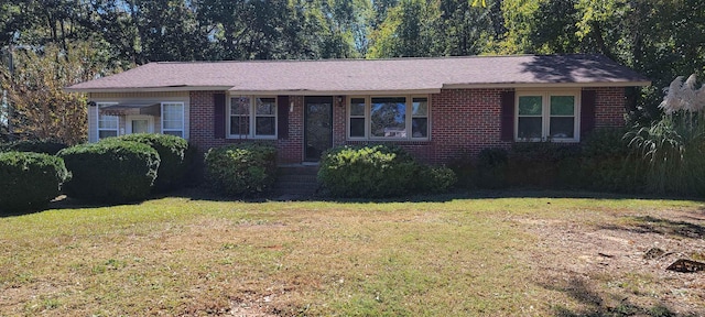 single story home featuring a front lawn and brick siding