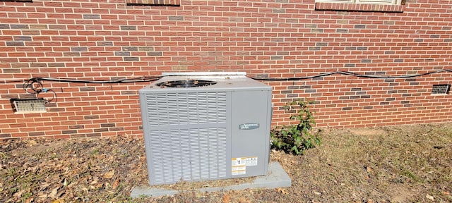 exterior details with brick siding and central air condition unit