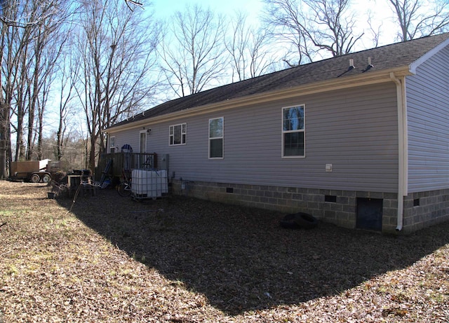 back of house with central AC unit