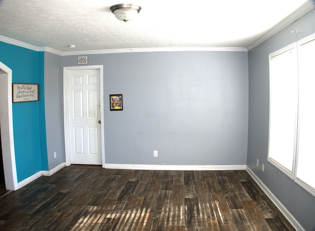 empty room with ornamental molding, a textured ceiling, and dark hardwood / wood-style flooring