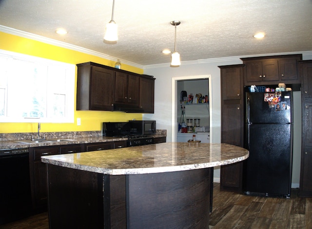 kitchen featuring crown molding, hanging light fixtures, dark hardwood / wood-style floors, dark brown cabinetry, and black appliances