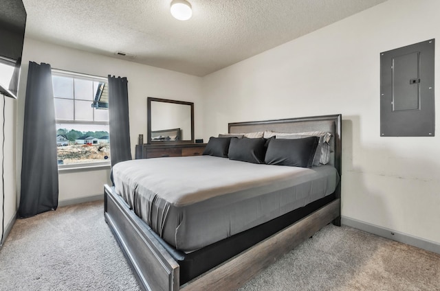 bedroom featuring electric panel, light carpet, and a textured ceiling