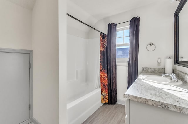 bathroom featuring vanity, wood-type flooring, and shower / bath combo