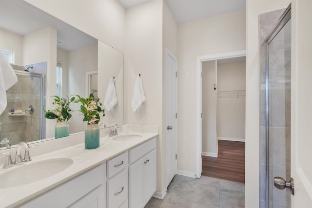 bathroom featuring vanity and a shower with door