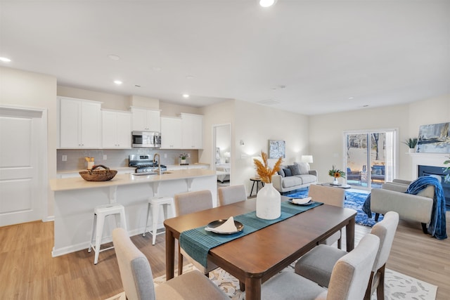 dining space with light hardwood / wood-style flooring