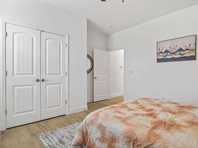 bedroom featuring a closet, ceiling fan, and light hardwood / wood-style flooring