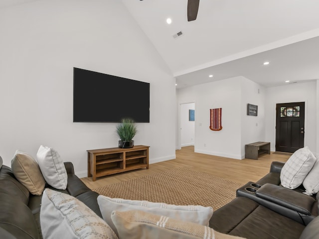 living room featuring ceiling fan, high vaulted ceiling, and light hardwood / wood-style flooring