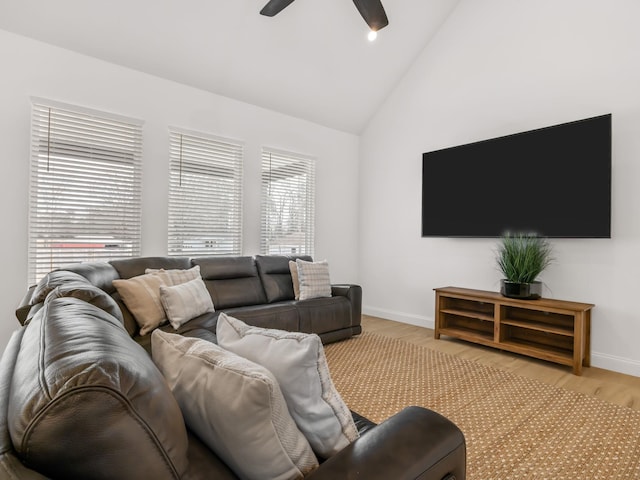 living room featuring ceiling fan, lofted ceiling, and light hardwood / wood-style floors