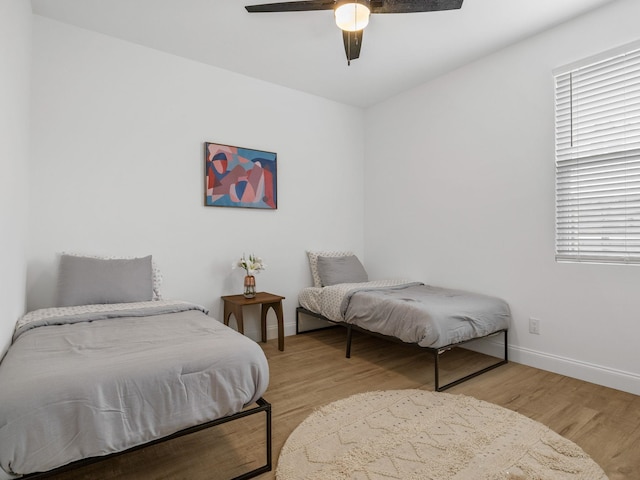 bedroom with ceiling fan and light hardwood / wood-style floors