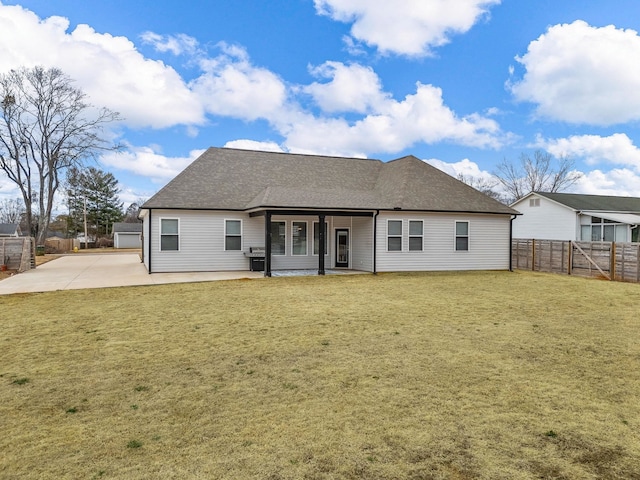 rear view of house with a yard and a patio