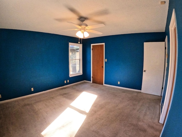 unfurnished bedroom with ceiling fan and carpet floors