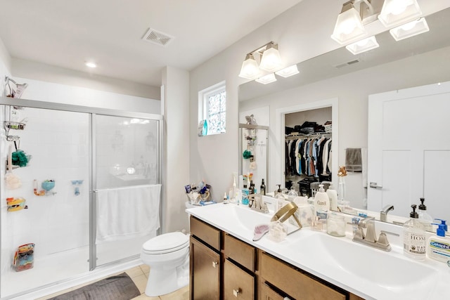 bathroom featuring tile patterned floors, an enclosed shower, and vanity