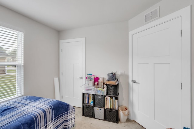 bedroom with light colored carpet