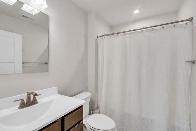 bathroom with vanity, toilet, and a shower with shower curtain