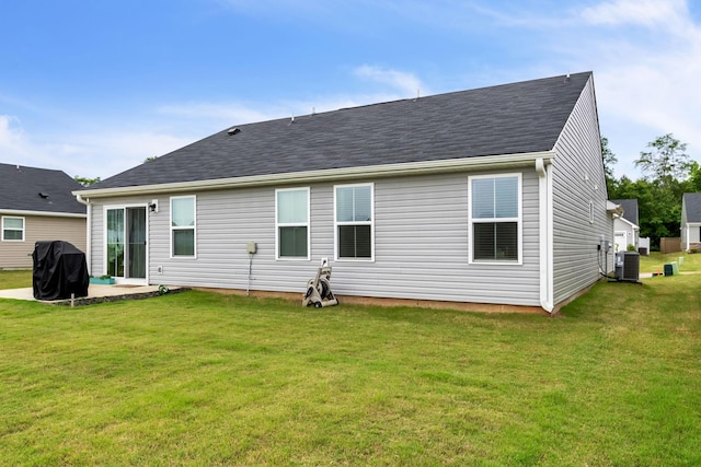 back of house featuring a yard, a patio, and central air condition unit