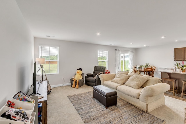 carpeted living room featuring plenty of natural light