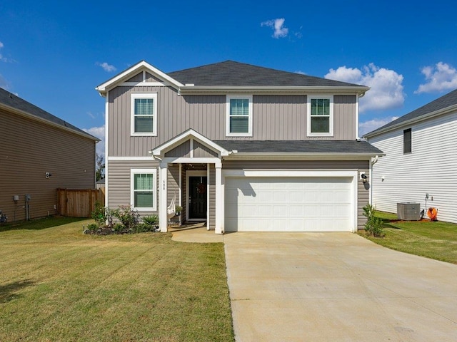 view of front of house with cooling unit, a garage, and a front lawn