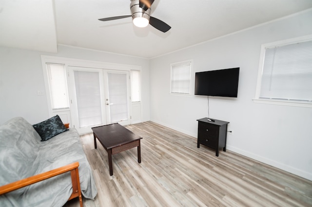 living room with ceiling fan, ornamental molding, light hardwood / wood-style floors, and french doors