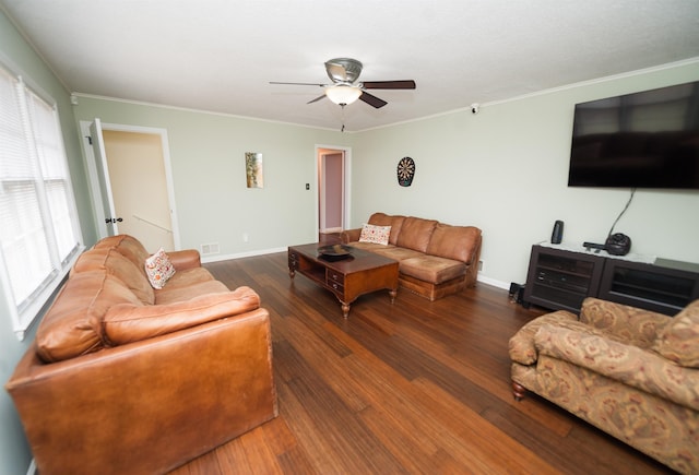 living room featuring dark hardwood / wood-style flooring, crown molding, and ceiling fan