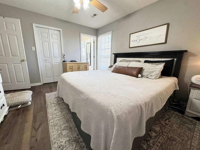 bedroom with ceiling fan, dark hardwood / wood-style floors, and a closet