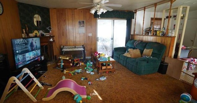 carpeted living room with wooden walls and ceiling fan