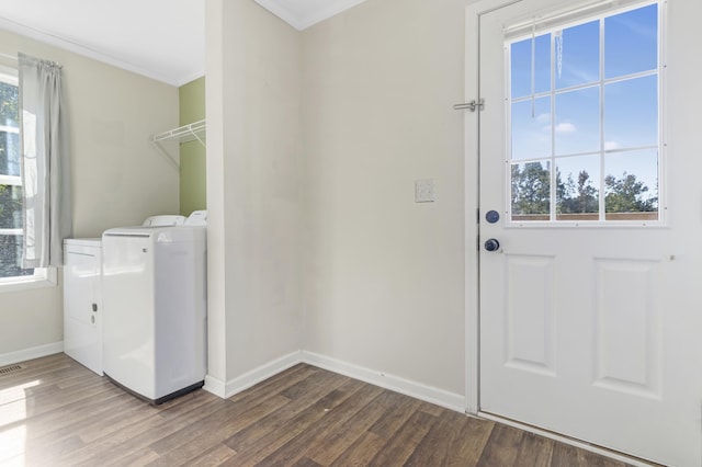 laundry room featuring washing machine and dryer, hardwood / wood-style floors, and crown molding