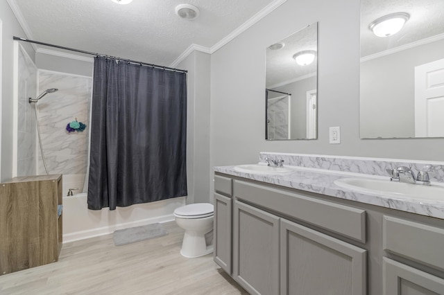 full bathroom with crown molding, vanity, shower / bath combo with shower curtain, and a textured ceiling