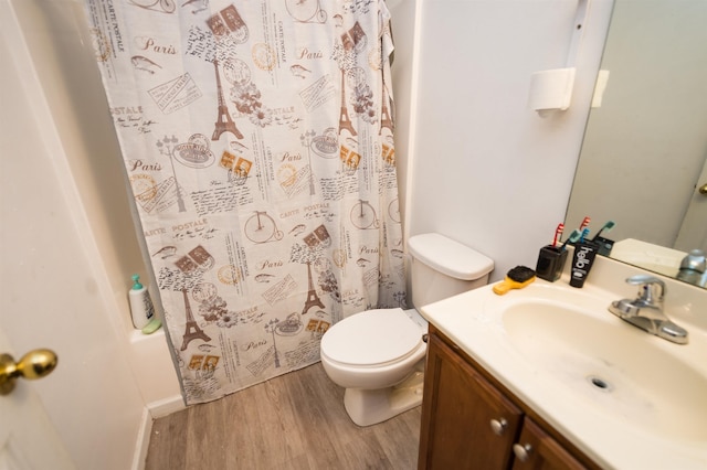 full bathroom featuring vanity, wood-type flooring, shower / bath combination with curtain, and toilet