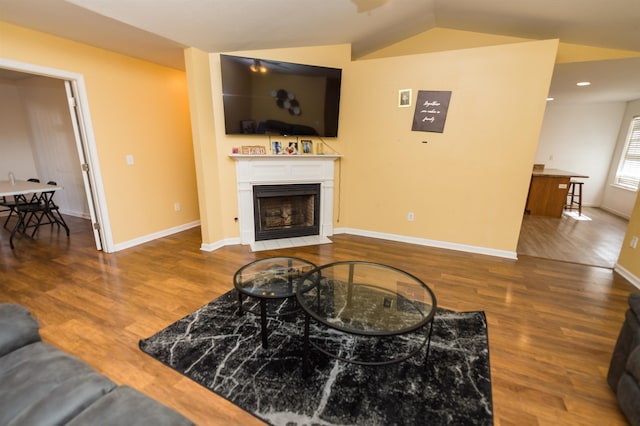 living room featuring hardwood / wood-style floors and vaulted ceiling