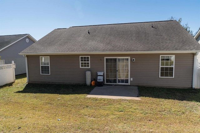 rear view of property featuring a patio and a lawn